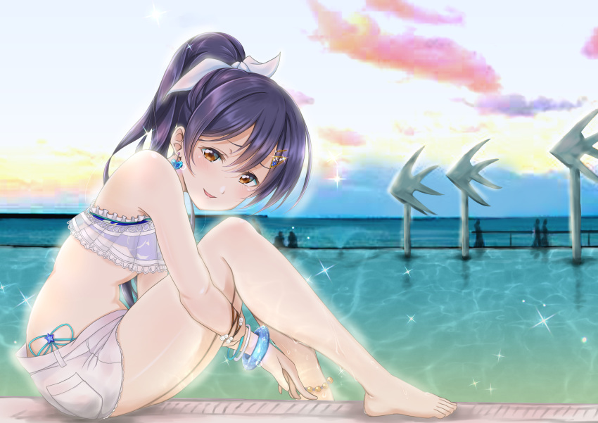 1girl absurdres bangs barefoot bikini bikini_under_clothes blue_hair blush bracelet commentary_request earrings frills from_side hair_between_eyes hair_ornament hairclip highres jewelry leg_hug long_hair looking_at_viewer love_live! love_live!_school_idol_project mun_(muuvu_uvuun) open_mouth outdoors ponytail shorts smile solo sonoda_umi swimsuit water
