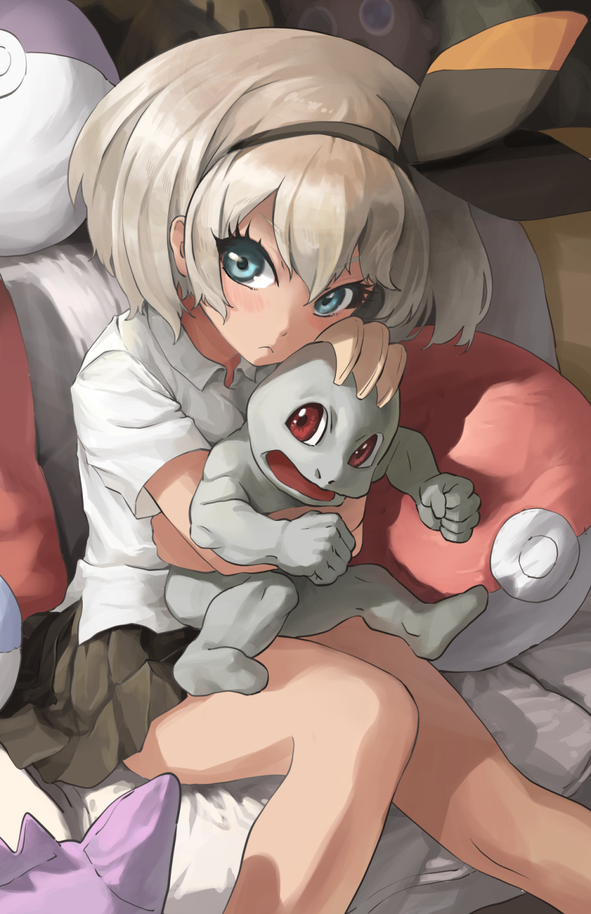 1girl bangs bea_(pokemon) black_hairband blue_eyes blush bow_hairband closed_mouth collared_shirt commentary couch eyelashes gen_1_pokemon grey_hair hair_between_eyes hairband highres holding holding_pokemon hug hug_from_behind looking_at_viewer machop melaton pleated_skirt poke_ball_theme pokemon pokemon_(creature) pokemon_(game) pokemon_swsh school_uniform shirt short_hair short_sleeves sitting skirt white_shirt