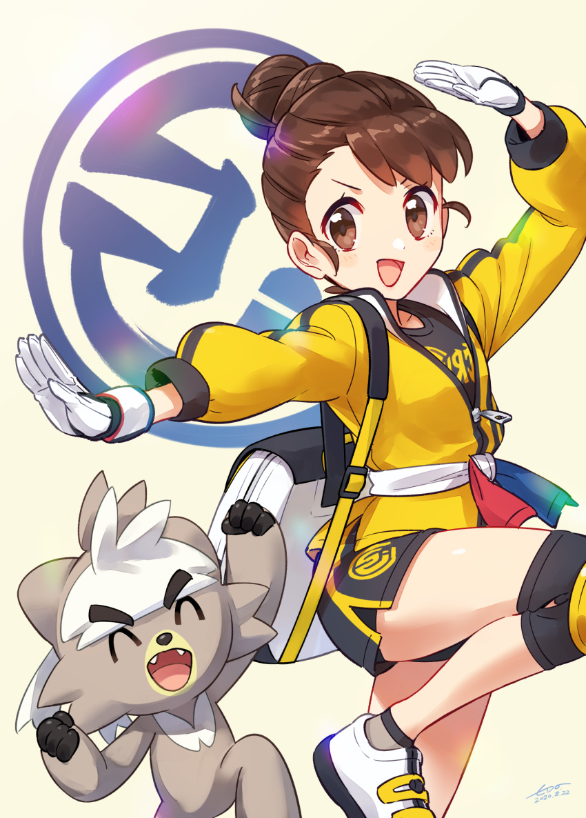 1girl :d arm_up backpack bag bangs black_shirt brown_eyes brown_hair commentary_request dynamax_band gen_8_pokemon gloves hair_bun hand_up highres jacket knee_pads kubfu leg_up legendary_pokemon looking_to_the_side master_dojo_uniform open_mouth pokemon pokemon_(creature) pokemon_(game) pokemon_swsh pose sash shirt shoes shorts smile socks tongue v-shaped_eyebrows wedo white_gloves yellow_jacket yuuri_(pokemon) zipper_pull_tab