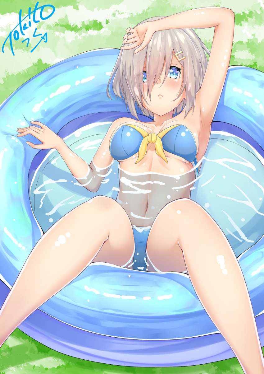 1girl bikini blue_bikini blue_eyes breasts collarbone commentary_request hair_ornament hair_over_one_eye hairclip hamakaze_(kantai_collection) highres kantai_collection large_breasts looking_at_viewer navel partially_submerged short_hair signature silver_hair sitting solo swimsuit tokito_yu wading_pool water