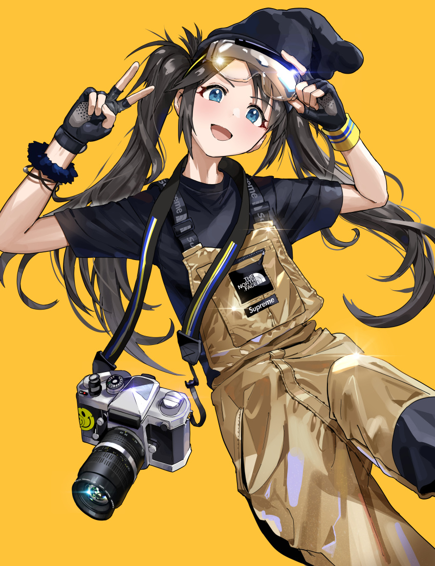 1girl :d absurdres arm_up bangs beanie black_gloves black_hair black_headwear black_shirt blue_eyes blush brown_background camera camera_around_neck commentary_request eyewear_on_head fingerless_gloves gloves goggles hand_up hat highres idolmaster idolmaster_shiny_colors lifted_by_self long_hair mitsumine_yuika open_mouth overalls shirt short_sleeves simple_background smile solo ssamjang_(misosan) supreme the_north_face twintails v very_long_hair