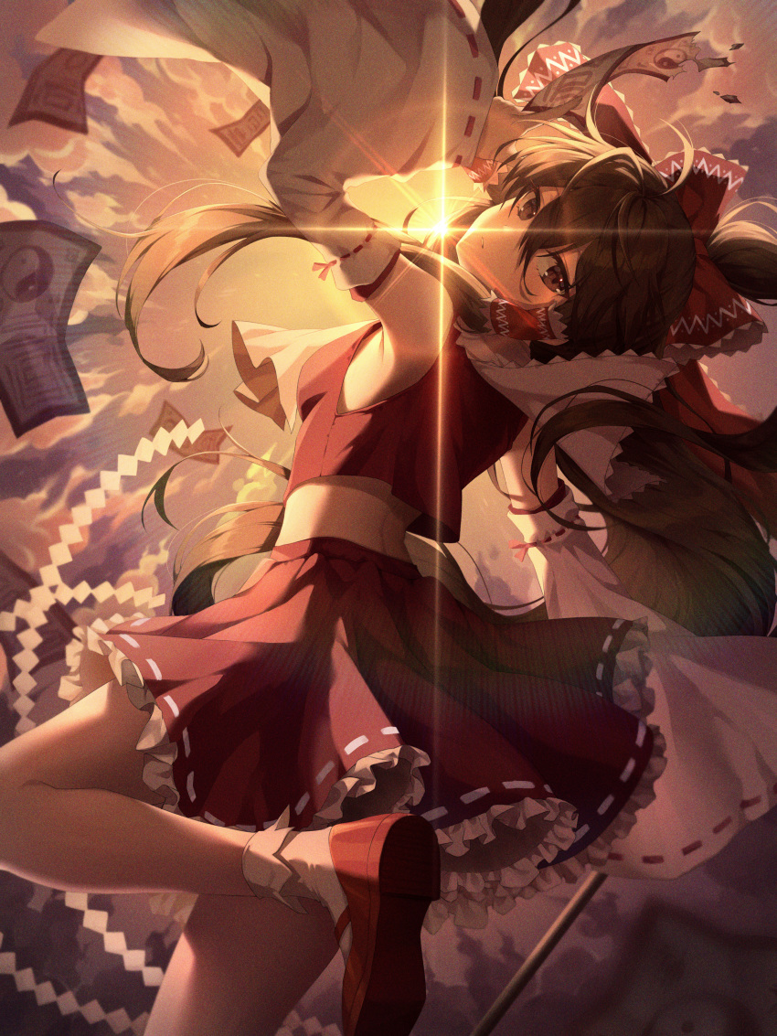 1girl absurdres armpits back bangs bare_shoulders bow brown_eyes brown_hair clouds cloudy_sky detached_sleeves evening film_grain flying frilled_skirt frills gohei hair_tubes hakurei_reimu highres huge_filesize lens_flare long_hair looking_at_viewer looking_back nontraditional_miko ofuda red_bow red_ribbon red_shirt red_skirt ribbon shirt shoes skirt sky socks solo sunlight touhou xiho_(suna) yin_yang