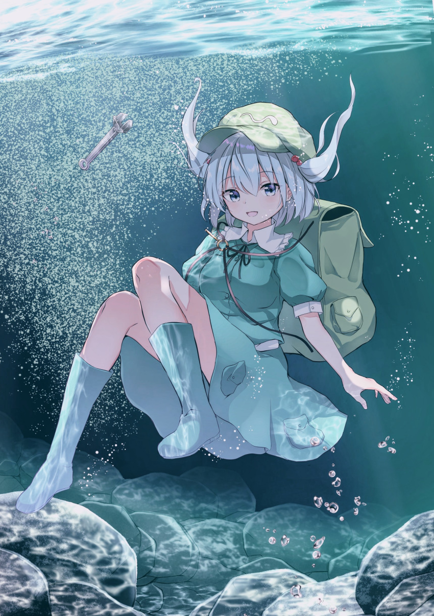 1girl absurdres air_bubble backpack bag blue_eyes blue_footwear blue_hair blue_shirt blue_skirt boots breasts bubble caustics commentary_request eyebrows_visible_through_hair flat_cap freediving green_headwear hair_between_eyes hair_bobbles hair_ornament hat highres iyo_(ya_na_kanji) kawashiro_nitori key looking_at_viewer medium_breasts parted_lips puffy_short_sleeves puffy_sleeves rock rubber_boots shirt short_hair short_sleeves skirt solo touhou two_side_up underwater wrench
