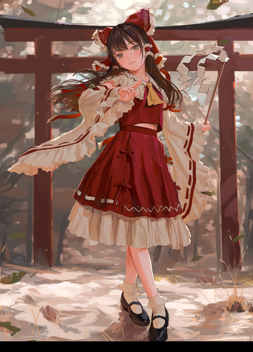 1girl artist_name ascot bell black_footwear bobby_socks bow brown_hair detached_sleeves fkey frilled_shirt_collar frills full_body gohei grey_eyes hair_bow hair_tubes hakurei_reimu head_tilt highres jingle_bell leaf long_hair looking_at_viewer mary_janes midriff_peek outdoors red_bow red_shirt red_skirt ribbon ribbon-trimmed_sleeves ribbon_trim shirt shoes skirt skirt_set socks solo standing torii touhou wide_sleeves yellow_neckwear