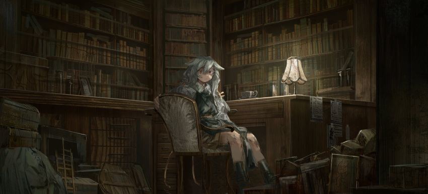 1girl book bookshelf brown_shorts chair closed_mouth cup desk grey_hair hair_flaps highres indoors lamp library long_hair looking_at_viewer messy_room original shichigatsu shirt shorts sitting sitting_sideways solo teacup white_shirt