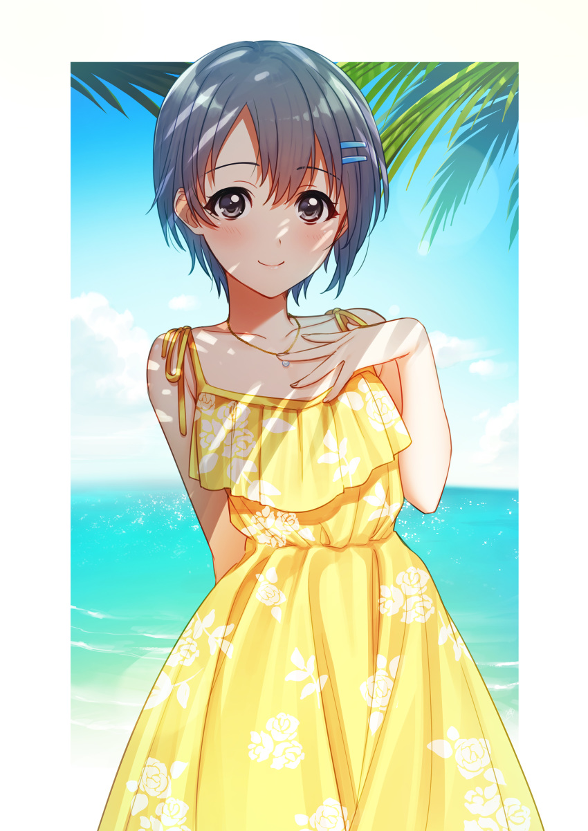 1girl absurdres arm_behind_back bangs bare_arms bare_shoulders blush border closed_mouth collarbone cowboy_shot day dress eyebrows_visible_through_hair fingernails floral_print grey_eyes grey_hair hair_between_eyes hair_ornament hairclip hand_on_own_chest hand_up highres horizon idolmaster idolmaster_cinderella_girls jewelry looking_at_viewer mikapoe necklace ocean otokura_yuuki outdoors outside_border palm_tree pendant print_dress shade short_hair sleeveless sleeveless_dress smile solo spaghetti_strap standing sundress tree tree_shade water white_border yellow_dress