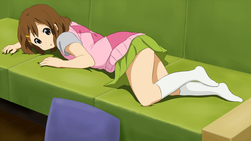 1girl blush brown_eyes brown_hair couch full_body green_skirt hair_ornament hairclip highres hirasawa_yui hirondo k-on! looking_at_viewer looking_back lying miniskirt on_couch on_stomach open_mouth pillow shiny shiny_hair short_hair skirt socks solo white_legwear