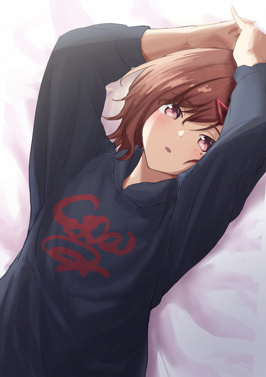 1girl absurdres arms_up bangs bed_sheet black_hoodie blush brown_eyes brown_hair commentary_request eyebrows_visible_through_hair hair_between_eyes hair_ornament hairclip hands_together highres higuchi_madoka hood hood_down hoodie idolmaster idolmaster_shiny_colors looking_at_viewer lying mole mole_under_eye on_back own_hands_together parted_lips solo tomatology3 upper_body