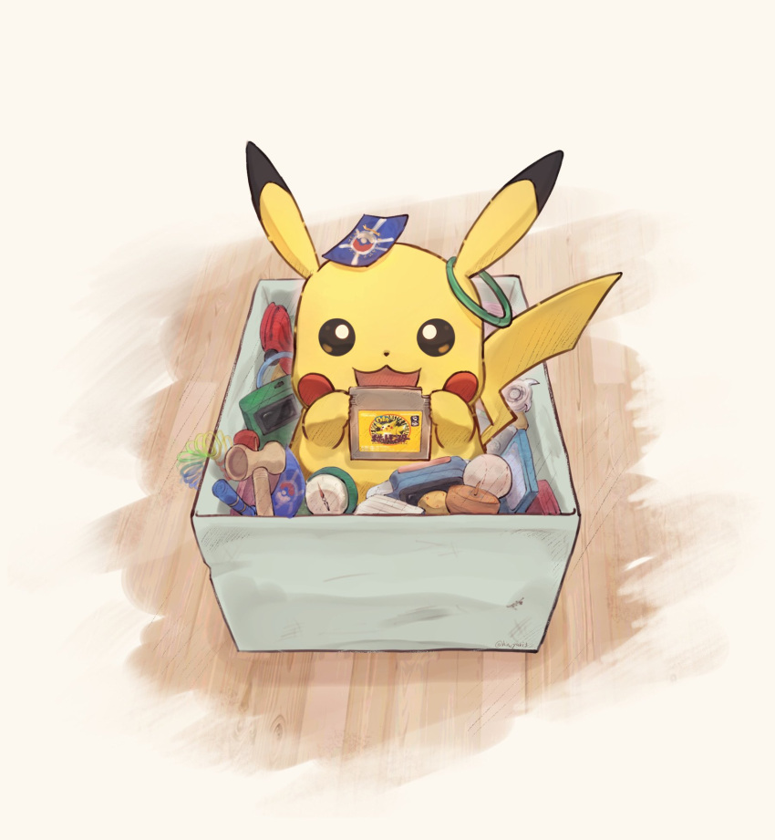 :3 box cartridge commentary_request from_above game_boy gen_1_pokemon handheld_game_console highres holding in_box in_container looking_at_viewer no_humans odd_(hin_yari) open_mouth pikachu pokemon pokemon_(creature) pokemon_card solo wooden_floor