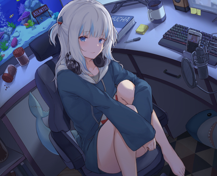 1girl bangs barefoot blue_eyes blue_hair blue_hoodie book cellphone chair collarbone cup desk drawer fish_food fish_tail fish_tank gawr_gura hair_ornament headphones headphones_around_neck highres hololive hololive_english hood hoodie keyboard knees_up long_sleeves looking_at_viewer medium_hair microphone monitor mug multicolored_hair pen phone pop_filter shark shark_girl shark_tail shiunnkaku sitting smartphone smile solo speaker sticky_note streaked_hair tail thighs two_side_up virtual_youtuber white_hair