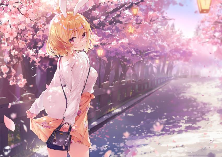 1girl :3 absurdres animal_ears bag bangs blonde_hair blush breasts bunny_girl bunny_tail cherry_blossoms closed_mouth cowboy_shot day eyebrows_visible_through_hair floral_print from_behind grass hair_between_eyes handbag highres holding holding_bag jewelry lantern lifted_by_self long_sleeves looking_at_viewer medium_breasts necklace odaefnyo orange_skirt original outdoors petals rabbit_ears short_hair skirt skirt_lift sky smile solo standing sweater tail violet_eyes water_drop white_sweater
