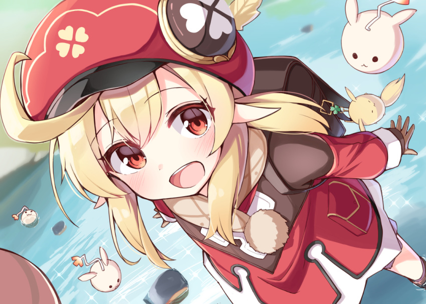 1girl :d backpack bag bag_charm bangs blonde_hair blurry blurry_background blush brown_gloves cabbie_hat charm_(object) commentary_request day depth_of_field dress eyebrows_visible_through_hair genshin_impact gloves hair_between_eyes hat klee_(genshin_impact) long_hair long_sleeves looking_at_viewer low_twintails ominaeshi_(takenoko) open_mouth outdoors pointy_ears red_dress red_eyes red_headwear shallow_water sleeves_past_wrists smile solo standing twintails upper_teeth water