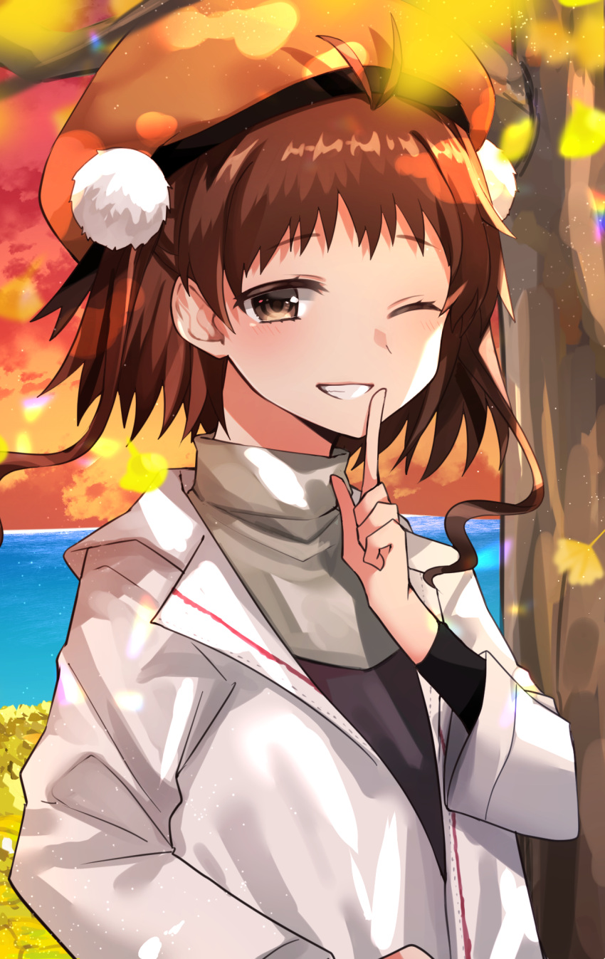 1girl alternate_costume bangs beret black_shirt brown_eyes brown_hair coat commentary_request finger_to_mouth grin hat highres index_finger_raised kantai_collection katsuobushi_(eba_games) long_sleeves looking_at_viewer naka_(kantai_collection) one_eye_closed orange_headwear pom_pom_(clothes) shirt short_hair shushing smile solo teeth tree upper_body white_coat