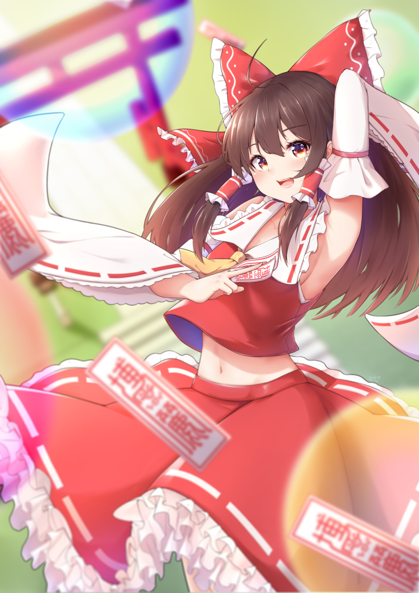 1girl :d absurdres anhun architecture arm_up armpits between_fingers blurry blurry_background blush bow breasts brown_hair collarbone cowboy_shot depth_of_field detached_sleeves east_asian_architecture energy_ball eyebrows_visible_through_hair hair_between_eyes hair_bow hakurei_reimu highres long_hair looking_at_viewer midriff_peek navel ofuda open_mouth petticoat red_bow red_eyes red_shirt red_skirt shirt skirt sleeveless sleeveless_shirt small_breasts smile solo standing torii touhou wide_sleeves wind wind_lift