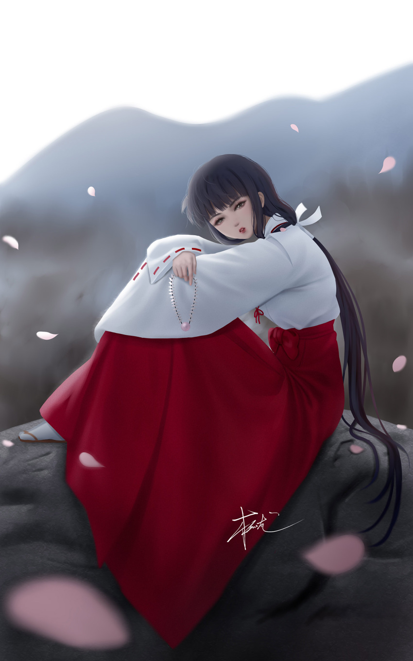 1girl absurdres black_hair blurry blurry_background brown_eyes hakama highres inuyasha japanese_clothes jewelry kikyou_(inuyasha) lips long_hair looking_at_viewer miko mountainous_horizon necklace outdoors petals ponytail red_hakama signature sitting solo zyl