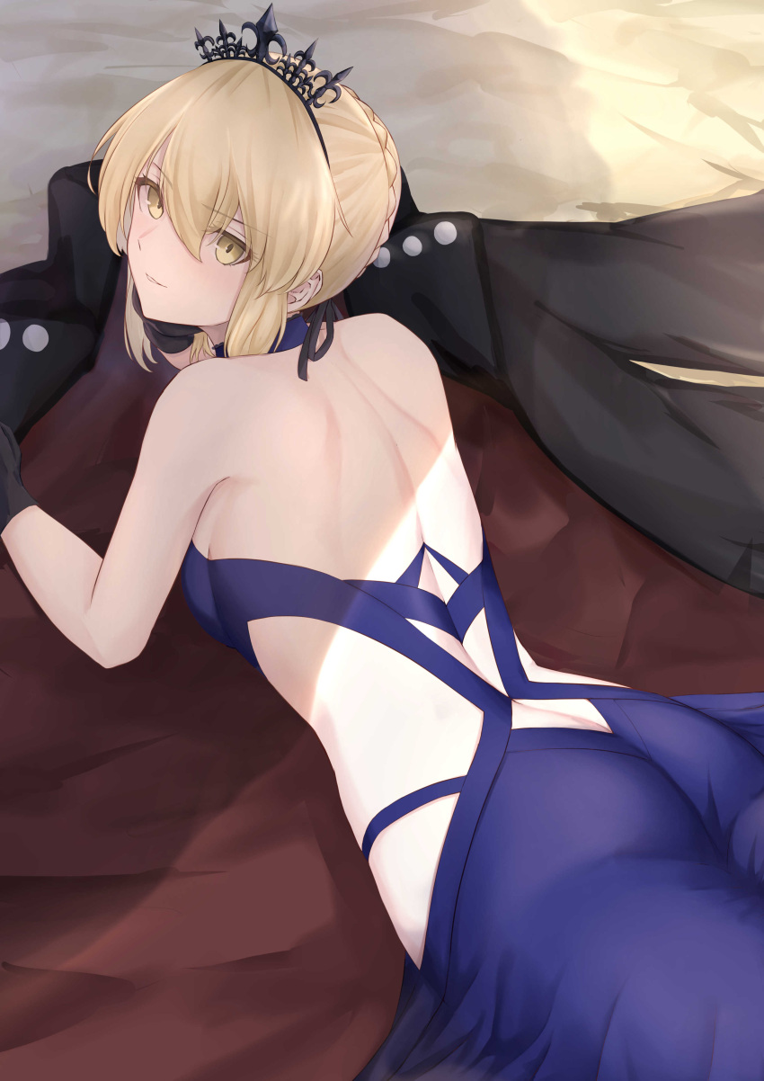 1girl absurdres artoria_pendragon_(all) artoria_pendragon_(swimsuit_rider_alter) ass back bangs bare_shoulders black_coat black_gloves blonde_hair blue_dress blush breasts closed_mouth coat dress fate/grand_order fate_(series) fuwatoromonta gloves highres long_hair looking_at_viewer looking_back lying medium_breasts on_stomach tiara yellow_eyes