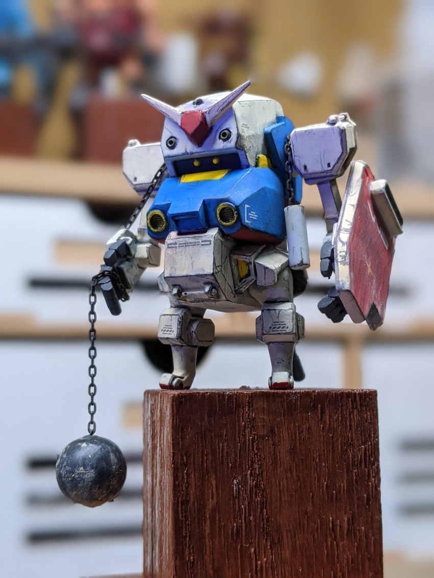 ball_and_chain blurry blurry_background cavico_models fusion gundam highres jgsdf_type_07_tank_natchin looking_ahead matage_sanjuro mecha mobile_suit_gundam model_kit no_humans open_hands photo_(medium) rx-78-2 shield v-fin yellow_eyes