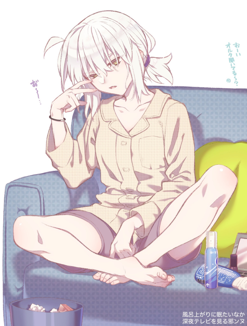 1girl bracelet brown_eyes casual commentary couch fate/grand_order fate_(series) hair_tie hand_on_own_face highres jeanne_d'arc_(alter)_(fate) jeanne_d'arc_(fate)_(all) jewelry long_sleeves makeup mitsurugi_sugar pink_shirt shirt shorts sleepy tied_hair translation_request trash_can white_hair