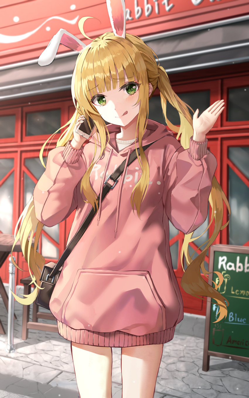 1girl :q absurdres ahoge animal_ears bag bangs blonde_hair building cellphone chair closed_mouth commentary drawstring english_commentary english_text eyebrows_visible_through_hair green_eyes hands_up highres holding holding_phone hood hood_down hoodie kerno long_sleeves looking_at_viewer menu_board original phone pink_hoodie puffy_long_sleeves puffy_sleeves rabbit_ears shoulder_bag sidelocks smile solo table tongue tongue_out twintails