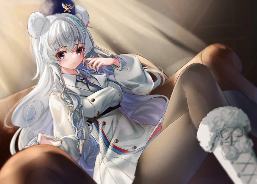 1girl animal_ears arknights bear_ears black_legwear blue_eyes blue_headwear blue_nails blue_neckwear blush boots breasts buttons coat commentary couch dutch_angle eyebrows_visible_through_hair feet_out_of_frame fur-trimmed_boots fur_trim hand_on_own_face hat highres large_breasts light_rays long_hair looking_at_viewer multicolored_hair necktie pantyhose pom_pom_(clothes) rosa_(arknights) rukinya_(nyanko_mogumogu) school_uniform sitting smile solo streaked_hair thighs uniform ursus_empire_logo very_long_hair white_coat white_footwear white_hair