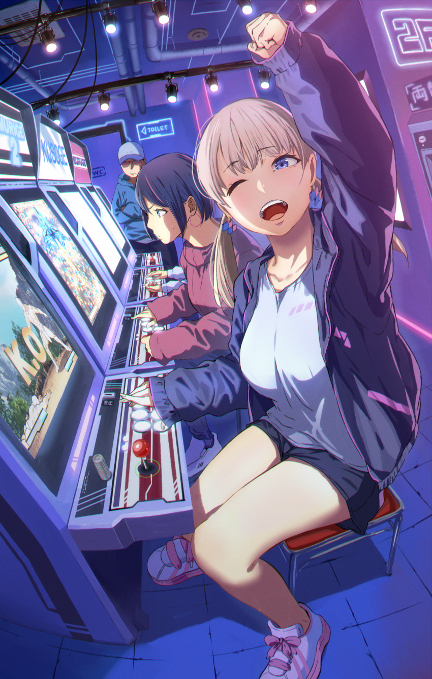1boy 2girls :d arcade arcade_cabinet baseball_cap black_hair blonde_hair blue_eyes breasts commentary danmaku dutch_angle earrings eyebrows_visible_through_hair fighting_game fist_pump hat highres hoop_earrings indoors jacket jewelry large_breasts looking_at_viewer multicolored_hair multiple_girls one_eye_closed open_mouth original pink_hair playing_games romaji_text short_hair short_shorts shorts sitting sleeves_past_wrists smile streaked_hair track_jacket twintails urasuji_samurai