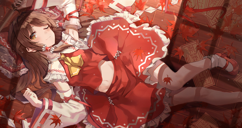 1girl absurdres ankle_socks ascot bobby_socks bow breasts brown_eyes closed_mouth commentary_request detached_sleeves eyebrows_visible_through_hair gohei hair_bow hair_tubes hakurei_reimu highres huge_filesize kerno leaf looking_at_viewer lying midriff midriff_peek navel on_back one_eye_closed red_bow red_skirt skirt smile socks solo touhou wide_sleeves yellow_neckwear