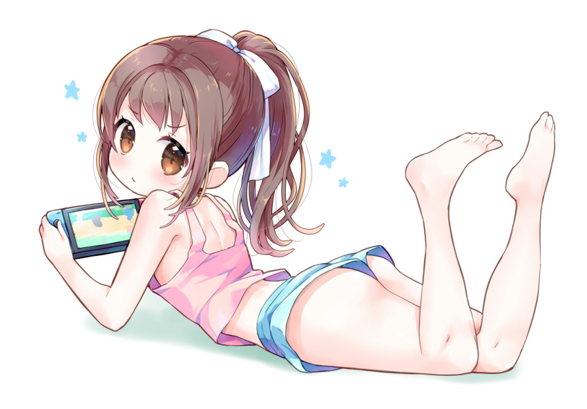 1girl amimi ass barefoot blue_shorts brown_eyes brown_hair commentary_request feet feet_up from_behind legs long_hair looking_at_viewer looking_back lying nintendo_switch on_stomach original pink_tank_top playing_games ponytail ribbon short_shorts shorts simple_background solo tank_top thighs toes white_background