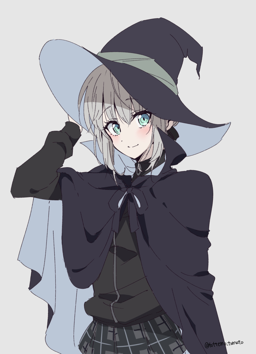 1girl absurdres alternate_costume arm_up artist_name bangs black_cape black_headwear black_skirt black_sweater blush cape chiri_to_mato closed_mouth commentary_request cowboy_shot eyebrows_visible_through_hair fate_(series) gray_(lord_el-melloi_ii) green_eyes grey_background grey_skirt hand_on_headwear hat highres long_sleeves looking_at_viewer lord_el-melloi_ii_case_files plaid plaid_skirt pleated_skirt short_hair simple_background skirt smile solo sweater witch_hat