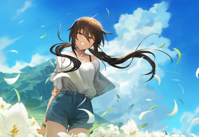 1girl arm_behind_back bangs blue_eyes blue_shorts blue_sky bracelet brown_hair clouds ecien grin hair_between_eyes holding_own_arm jewelry leaf leaves_in_wind long_hair mountain original outdoors shirt short_shorts shorts sky smile standing tan thighs white_shirt