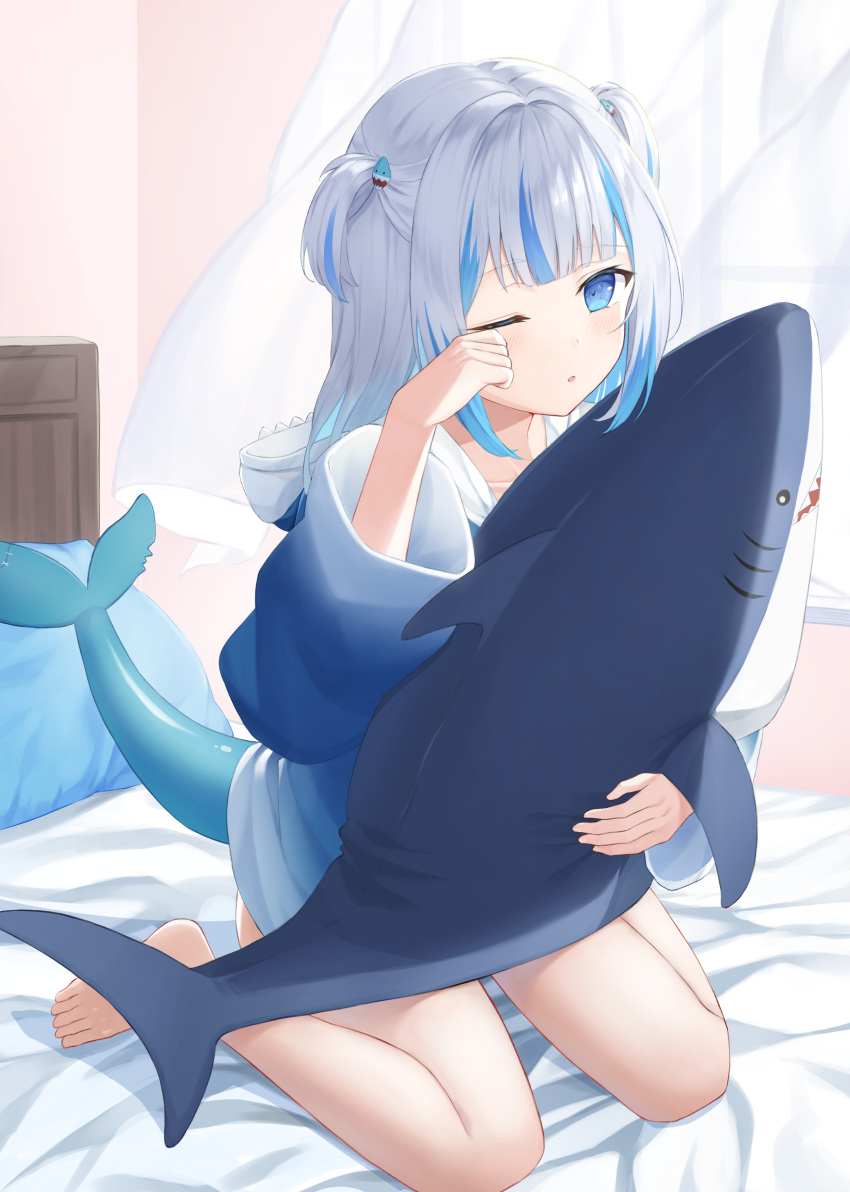 1girl ;o absurdres bangs barefoot blue_eyes blue_hoodie blunt_bangs collarbone curtains eyebrows_visible_through_hair fish_tail full_body gawr_gura gradient_clothes hair_ornament highres holding holding_stuffed_toy hololive hololive_english hood hoodie hukw indoors long_hair multicolored_hair on_bed one_eye_closed pillow rubbing_eyes shark_hair_ornament shark_tail silver_hair sitting solo streaked_hair stuffed_animal stuffed_shark stuffed_toy tail two_side_up virtual_youtuber wariza wide_sleeves window