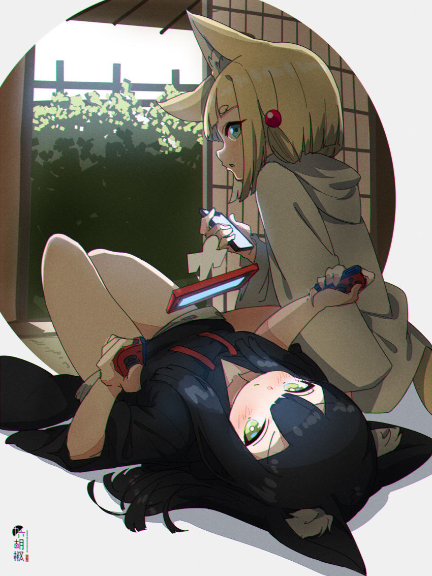 2girls animal_ear_fluff animal_ears bangs black_hair black_hoodie blonde_hair blush cellphone closed_mouth commentary_request drawstring eyebrows_visible_through_hair fox_ears fox_girl fox_tail green_eyes grey_shorts hair_between_eyes highres holding holding_phone hood hood_down hoodie kuro-chan_(kuro_kosyou) kuro_kosyou long_hair long_sleeves lying multiple_girls nintendo_switch on_back original parted_lips phone shikigami short_eyebrows short_shorts shorts sitting tail thick_eyebrows white_hoodie wide_sleeves