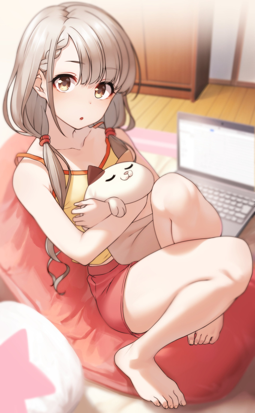 1girl :o absurdres bare_arms bare_legs bare_shoulders barefoot blurry blurry_background braid braided_bangs cabinet camisole carpet collarbone computer cushion depth_of_field eyebrows_visible_through_hair fingernails from_above full_body grey_hair hair_tie highres hisakawa_nagi idolmaster idolmaster_cinderella_girls indoors kakaobataa knees_up laptop light_blush long_hair looking_at_viewer low_twintails object_hug parted_lips red_shorts room shiny shiny_hair shorts sitting solo spaghetti_strap stuffed_animal stuffed_cat stuffed_toy toenails toes twintails wooden_floor yellow_camisole yellow_eyes