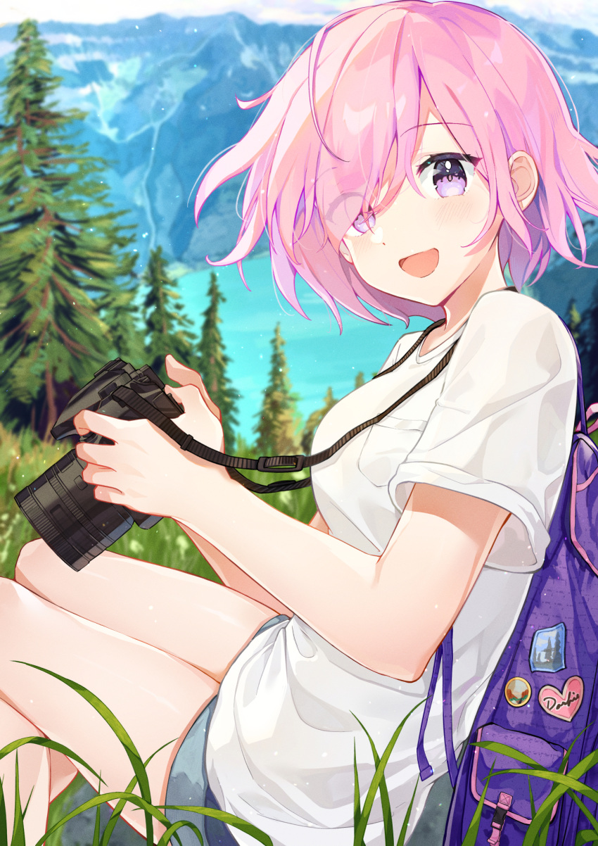 1girl :d acco_(sh_in) alternate_costume backpack badge bag breasts button_badge camera casual commentary day denim denim_shorts eyebrows_visible_through_hair eyes_visible_through_hair fate/grand_order fate_(series) grass hair_over_one_eye highres holding holding_camera lake mash_kyrielight medium_breasts mountain nature open_mouth outdoors pink_hair shirt short_hair short_sleeves shorts sitting smile solo t-shirt tree violet_eyes white_shirt