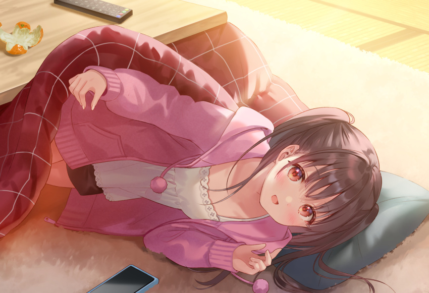 1girl :d bangs black_shorts blush brown_hair camisole cardigan carpet cellphone collarbone commentary_request controller drawstring eyebrows_visible_through_hair fukahire_(ruinon) hood hood_down hooded_cardigan indoors kotatsu long_hair long_sleeves looking_at_viewer open_cardigan open_clothes open_mouth orange_peel original phone pillow pink_cardigan pom_pom_(clothes) red_eyes remote_control shorts smartphone smile solo table twintails under_kotatsu under_table unzipped