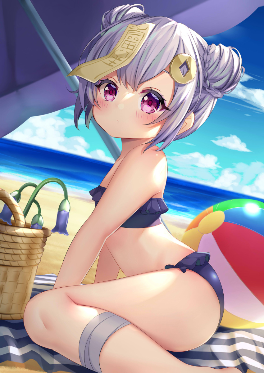 1girl absurdres ass ball bandaged_leg bandages bare_arms bare_shoulders beach beachball bikini blue_bikini blue_flower blue_sky blush braid closed_mouth clouds commentary_request day double_bun feet_out_of_frame flower frilled_bikini frills from_side genshin_impact hair_ornament highres horizon ikazu401 looking_at_viewer looking_to_the_side ocean ofuda outdoors qiqi_(genshin_impact) sidelocks silver_hair sitting sky solo strapless strapless_bikini swimsuit violet_eyes wariza water