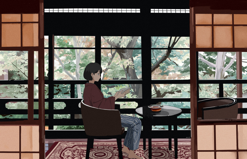 1girl barefoot black_hair book brown_shirt chair gumi. highres holding holding_book indoors leaf long_sleeves open_book original pants print_pants profile shadow shirt short_hair sitting solo table tree wide_shot window