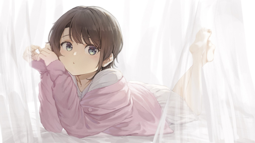 1girl bangs barefoot black_hair blush collarbone curtains eyebrows_behind_hair green_eyes highres hololive kanoe_(tatsukanoe) looking_at_viewer lying on_bed on_stomach oozora_subaru pink_sweater shirt short_hair soles solo sweater white_shirt