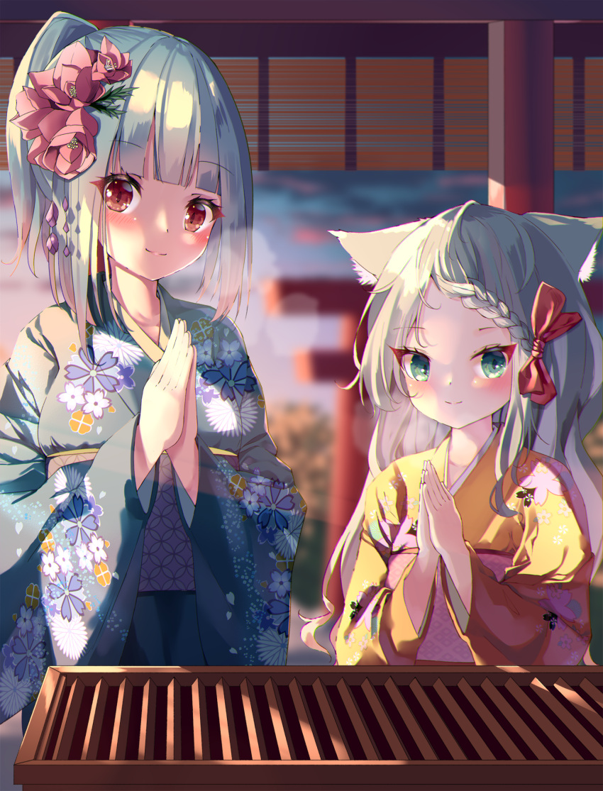 2girls animal_ear_fluff animal_ears bangs blue_kimono blurry blurry_background bow braid braided_bangs breath closed_mouth commentary_request depth_of_field eyebrows_visible_through_hair floral_print flower green_eyes grey_hair hair_bow hair_flower hair_ornament hamaru_(s5625t) highres japanese_clothes kimono long_hair long_sleeves looking_at_viewer multiple_girls obi original outdoors palms_together parted_bangs pink_flower ponytail praying print_kimono red_bow red_eyes sash smile sunrise torii yellow_kimono