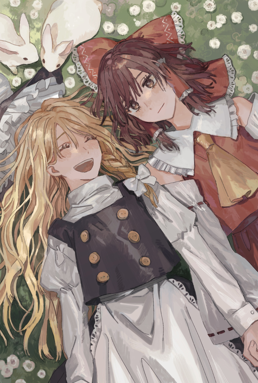 2girls :d apron black_dress bow brown_eyes brown_hair closed_eyes detached_sleeves dress from_above hair_bow hair_tubes hakurei_reimu hat hat_removed headwear_removed highres holding_hands isshin_(kaxz) japanese_clothes juliet_sleeves kirisame_marisa long_hair long_sleeves lying meadow medium_hair miko multiple_girls on_back open_mouth outdoors puffy_sleeves rabbit red_bow sidelocks smile touhou waist_apron white_bow witch_hat yellow_neckwear yuri