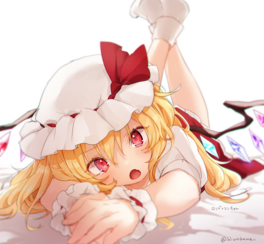 1girl blonde_hair blurry blush depth_of_field fang flandre_scarlet foreshortening hat hat_ribbon head_tilt highres honotai long_hair looking_at_viewer lying mob_cap on_stomach open_mouth red_eyes red_ribbon red_skirt ribbon shirt short_sleeves simple_background skin_fang skirt socks solo touhou twitter_username white_background white_headwear white_legwear white_shirt wings wrist_cuffs