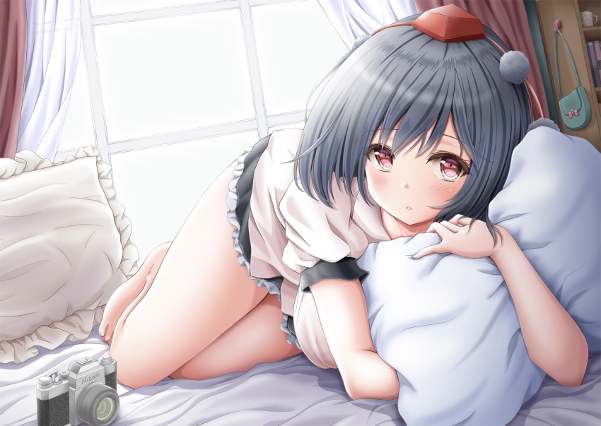 1girl :o akino_irori bag bangs barefoot bed_sheet black_hair black_skirt blush bookshelf breasts camera coffee_mug commentary_request cup curtains day eyebrows_visible_through_hair handbag hat indoors large_breasts looking_at_viewer lying microskirt mug on_bed on_side parted_lips partial_commentary petticoat pillow pillow_hug pom_pom_(clothes) puffy_short_sleeves puffy_sleeves red_eyes red_headwear shameimaru_aya shirt short_hair short_sleeves skirt solo tareme thighs tokin_hat touhou untucked_shirt white_shirt window