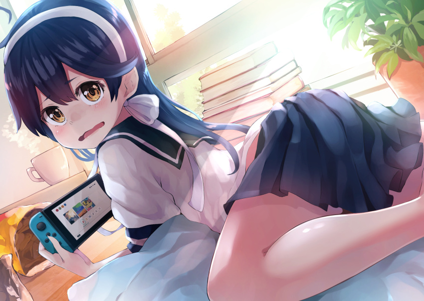 1girl black_hair blue_skirt blush book brown_eyes cup food hair_between_eyes handheld_game_console highres holding holding_handheld_game_console kantai_collection long_hair nintendo_switch open_mouth pleated_skirt school_uniform serafuku short_sleeves skirt solo taisho_(gumiyuki) ushio_(kancolle) window