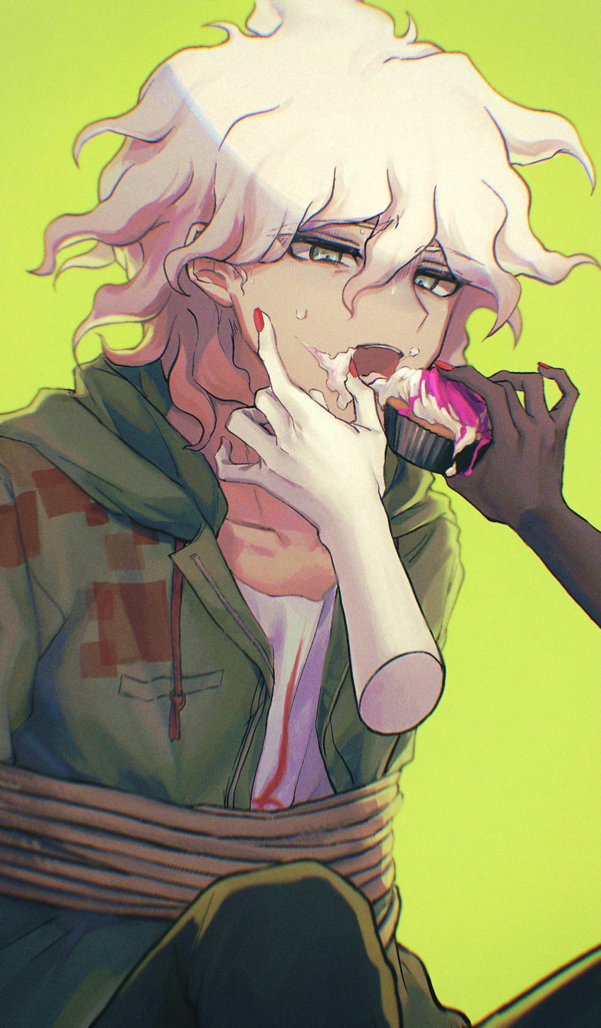 1boy 1girl absurdres aji_kosugi brown_pants coat collarbone commentary_request cupcake dangan_ronpa_(series) dangan_ronpa_2:_goodbye_despair disembodied_limb enoshima_junko feeding food food_on_face green_background green_coat grey_hair hair_between_eyes highres holding holding_food komaeda_nagito male_focus messy_hair nail_polish open_clothes open_coat open_mouth pants red_nails restrained rope shirt solo_focus white_shirt