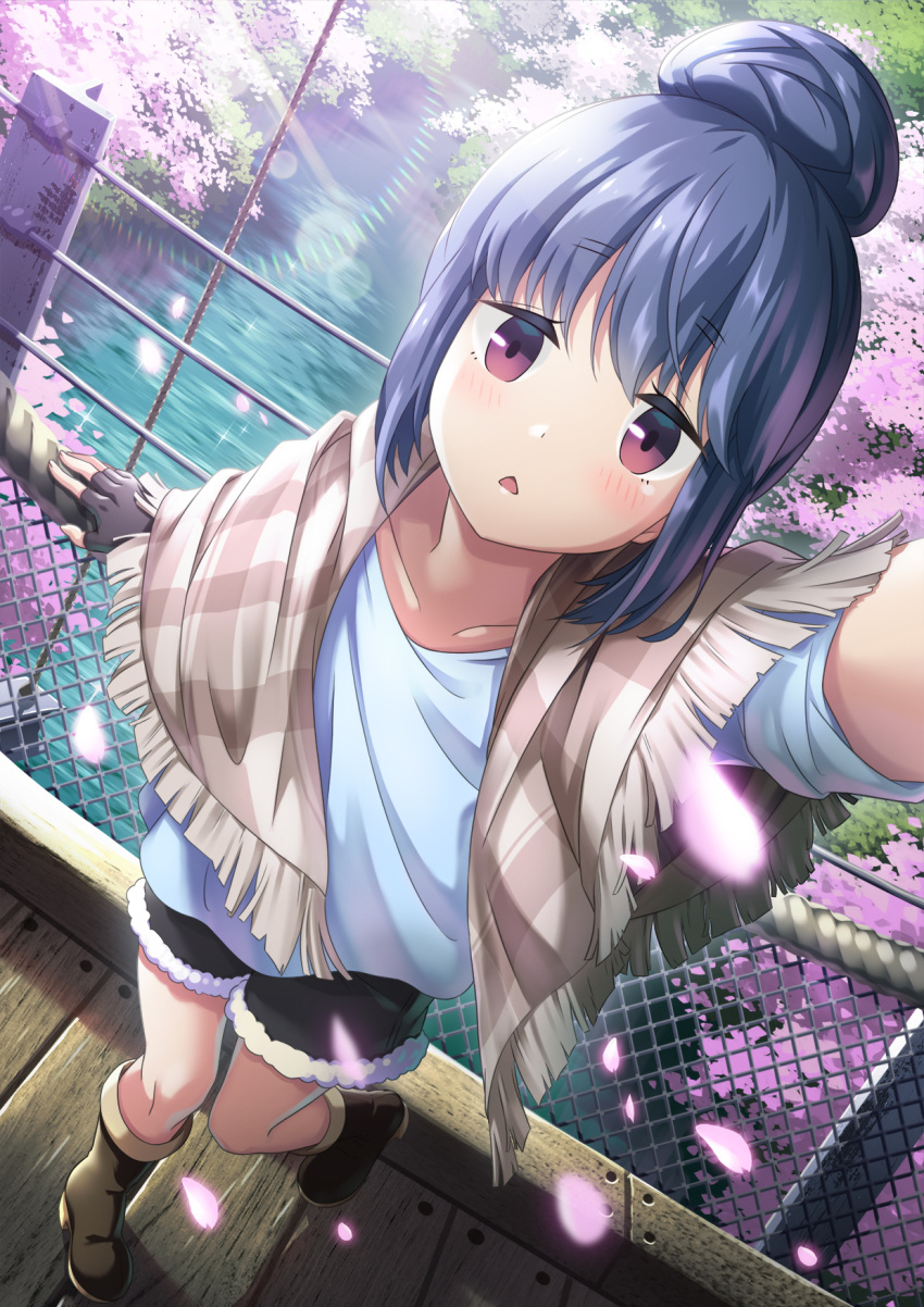 1girl arm_up bangs beige_scarf black_shorts blue_hair blue_shirt blush boots brown_footwear checkered checkered_scarf cherry_blossoms collarbone commentary_request day eyebrows_visible_through_hair falling_petals fingerless_gloves fur-trimmed_legwear fur-trimmed_shorts fur_trim gloves hair_bun highres kuromasu light_particles light_rays looking_at_viewer outdoors outstretched_arm petals reaching_out river rope scarf scenery selfie shima_rin shirt shorts sleeves_rolled_up solo spring_(season) standing standing_on_one_leg sunlight t-shirt tree triangle_mouth violet_eyes water wooden_bridge wooden_floor yurucamp