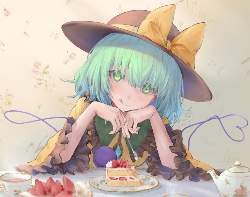 1girl :q bangs black_headwear blouse bow bright_pupils cake cake_slice closed_mouth cup eyeball eyebrows_behind_hair floral_background floral_print food food_on_face fork frilled_shirt_collar frills fruit green_eyes green_hair hair_between_eyes hands_on_own_cheeks hands_on_own_face hands_up hat hat_bow head_rest head_tilt heart heart_of_string highres holding holding_fork indoors io_(io_oekaki) komeiji_koishi light_blush looking_at_viewer plate short_hair simple_background smile solo strawberry teacup teapot third_eye tongue tongue_out touhou upper_body wall white_pupils wide_sleeves yellow_blouse yellow_bow