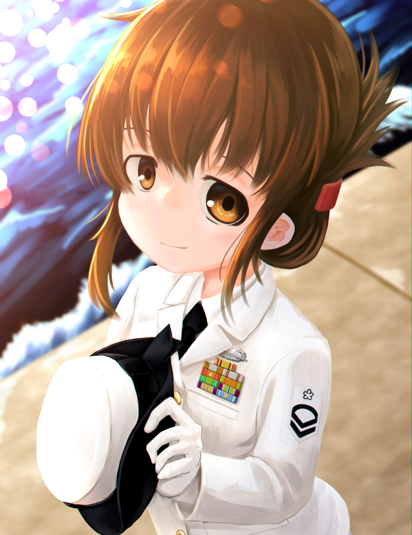 1girl alternate_costume badge brown_eyes brown_hair cowboy_shot female_service_cap folded_ponytail hat hat_removed headwear_removed highres inazuma_(kancolle) kantai_collection kunsei_hamu long_hair looking_at_viewer military military_uniform naval_uniform peaked_cap smile solo uniform upper_body water white_headwear