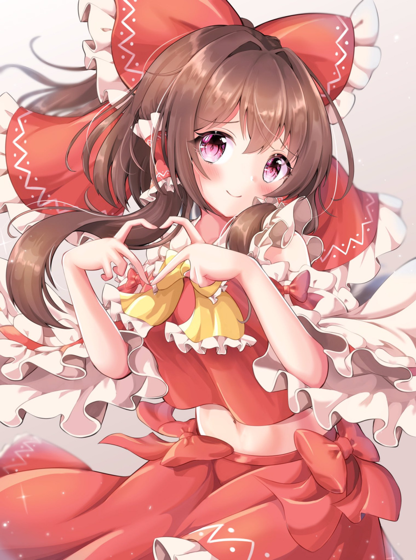 1girl ascot bangs bare_shoulders blurry blush bow bowtie breasts brown_hair closed_mouth commentary_request cowboy_shot depth_of_field detached_sleeves eyebrows_visible_through_hair finger_heart floating_hair frills grey_background hair_bow hair_intakes hair_tubes hakurei_reimu highres long_hair looking_at_viewer medium_breasts midriff navel pink_eyes red_bow red_skirt red_vest simple_background skirt smile solo touhou vest yellow_bow yellow_neckwear yuyu_hane
