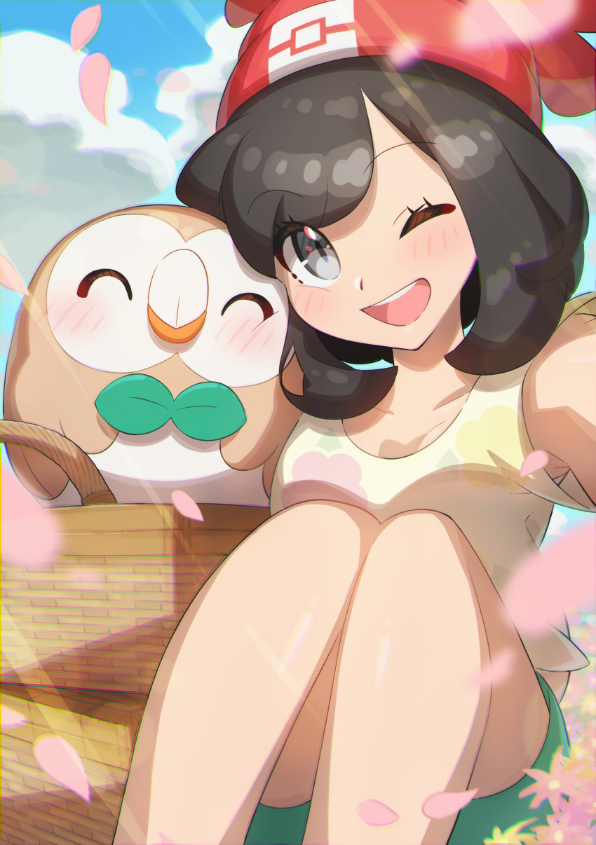 1girl ;d absurdres bangs basket beanie blush brown_hair clouds commentary_request day eyelashes floral_print gen_7_pokemon green_shorts grey_eyes hat highres knees_together looking_at_viewer one_eye_closed open_mouth outdoors petals pokemon pokemon_(creature) pokemon_(game) pokemon_sm red_headwear rowlet selene_(pokemon) shiny shiny_skin shirt short_sleeves shorts sky smile starter_pokemon t-shirt taisa_(lovemokunae) tongue upper_teeth