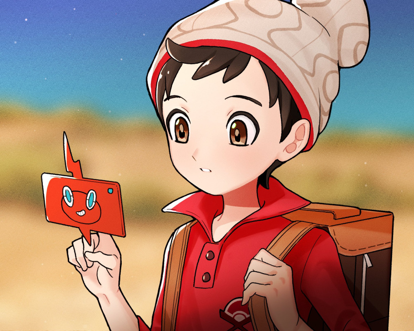 1boy amakara000 beanie blurry blurry_background brown_eyes brown_hair buttons cable_knit gen_4_pokemon grey_headwear hands_up hat highres holding_strap male_focus parted_lips pokemon pokemon_(game) pokemon_swsh red_shirt rotom rotom_phone shirt short_hair sleeves_rolled_up suitcase upper_body victor_(pokemon)