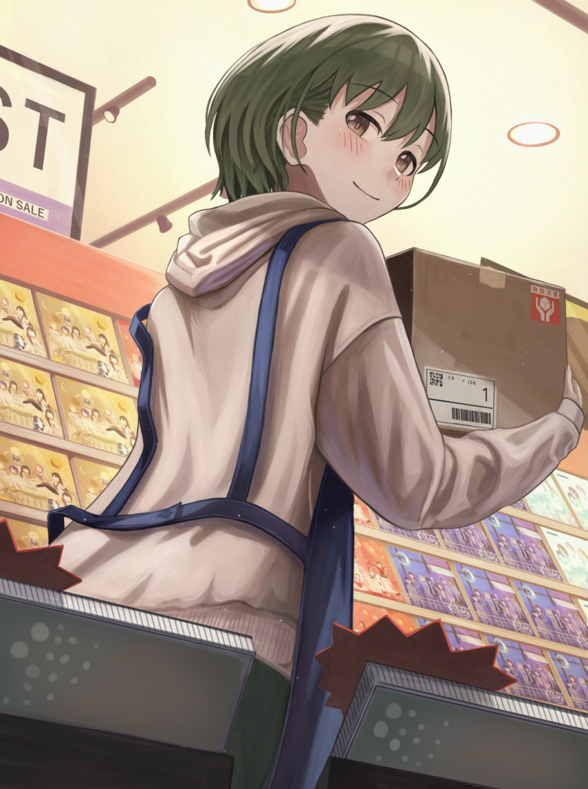 1girl apron blue_apron blush box brown_eyes carrying casual cd_case display_case from_below green_hair highres hood hoodie idolmaster idolmaster_shiny_colors long_sleeves looking_back nanakusa_nichika record_store shop short_hair solo working yanoyoru